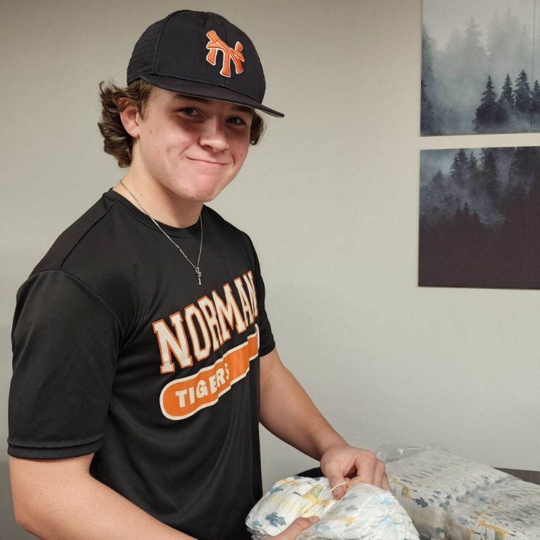 Student sorts diapers for diaper pantry