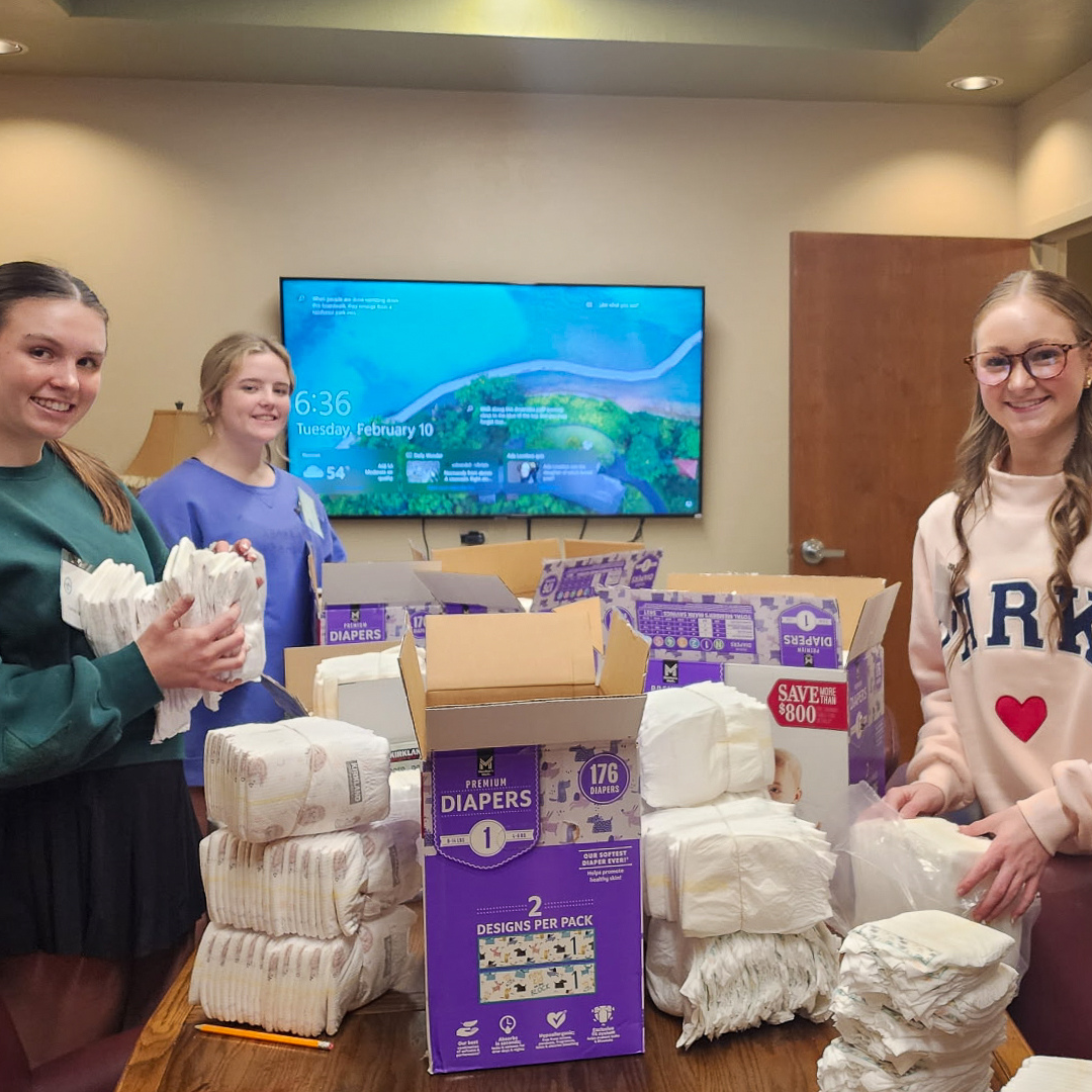 Volunteers sort diapers