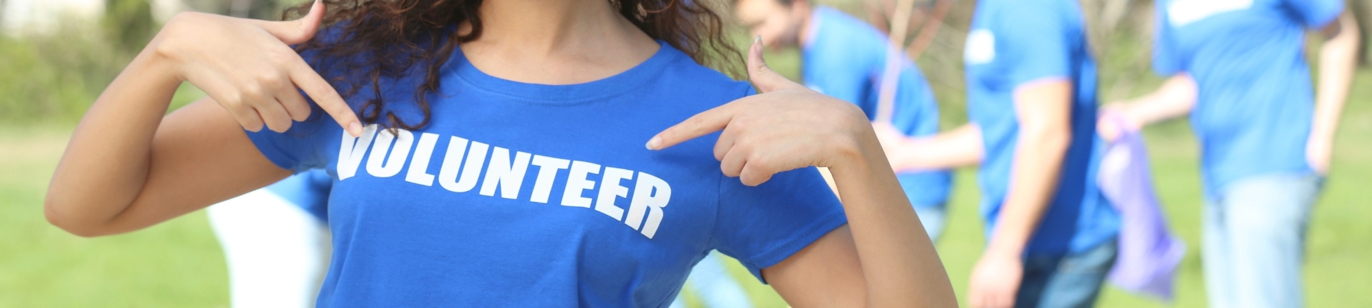 Person wearing a shirt that says volunteer
