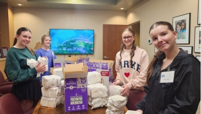 Volunteers sort diapers for nonprofit